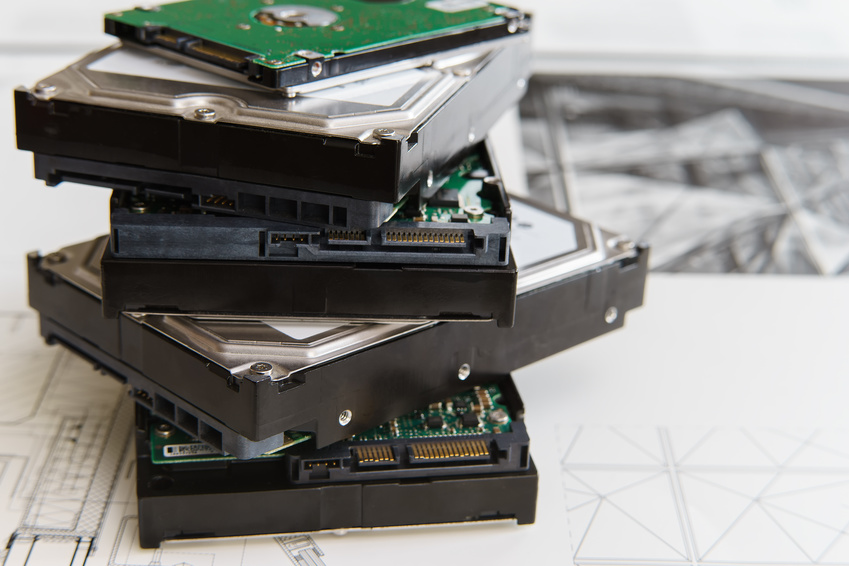 pile of old hard drives at white background